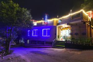 a building with blue lights on it at night at Hotel Shiva Lake Mussoorie - 360 Degree View - Free Parking in Mussoorie