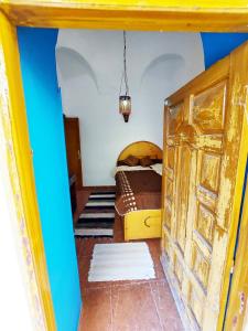 a bedroom with a bed and a wooden door at Villa Cleopatra Luxor west bank in Luxor