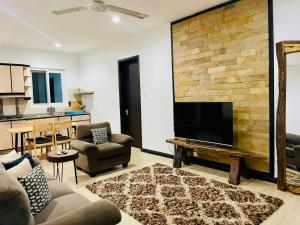a living room with a fireplace and a tv at Two Bedroom House With free WiFi in Masaki in Dar es Salaam