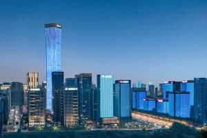 a view of a large city skyline at night at Kempinski Hotel Jinan in Jinan