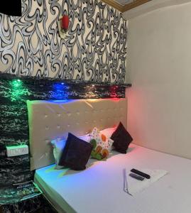 a room with a bed with lights on it at Relax Zone in Patna
