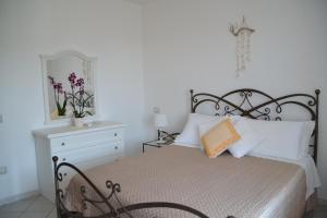 A bed or beds in a room at Casa delle Conchiglie