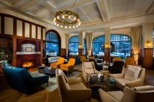 a living room filled with furniture and a fireplace at Kempinski Palace Engelberg in Engelberg