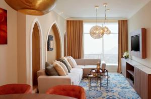 a living room with a couch and a tv at Shaza Makkah in Makkah