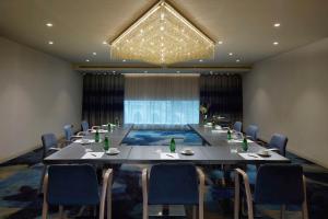 a conference room with a long table and chairs at Shaza Makkah in Makkah