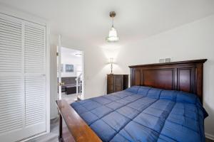 a bedroom with a blue comforter on a bed at Channel Lake Getaway home in Antioch