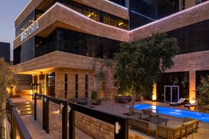 a hotel with a swimming pool in front of a building at Bristoria Hotel Erbil in Erbil