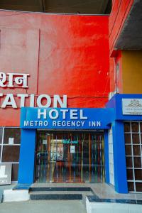a hotel sign on the side of a building at HOTEL METRO REGENCY INN in Jaipur