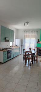 a kitchen with a table and chairs and a dining room at Pia's house garden in Campobasso
