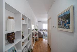 a hallway with white shelves in a living room at The view of Kotor - Sea & Old town view in Kotor