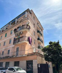 a tall building with cars parked in front of it at Casetta Tuscolana in Rome