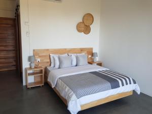 a bedroom with a large bed and two night stands at Villas Rocher - Junior Suite 3B in Grand Baie