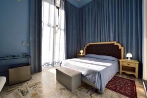 Dormitorio azul con cama y ventana grande en A Casa Di Laura, en Catania