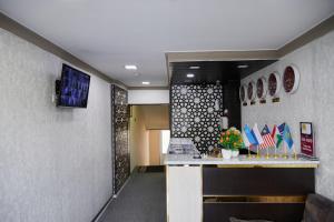 a lobby with a waiting area with flags on the wall at Hotel ART PALACE TASHKENT in Chilanzar