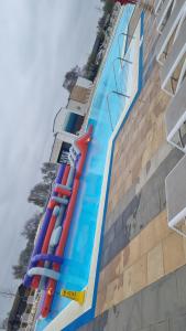 a large swimming pool next to a building at Luxury caravan and Tattershall lakes with private hot tub and WiFi in Tattershall