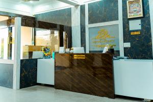 an office with a desk with a sign on the wall at HOTEL METRO REGENCY INN in Jaipur