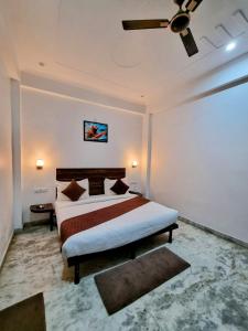 Hotel Sangam View في الله أباد: غرفة نوم بسرير ومروحة سقف