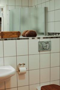 a bathroom with a toilet and a sink and a mirror at Valleviken Hotell in Valleviken