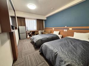 Ένα ή περισσότερα κρεβάτια σε δωμάτιο στο Hotel 1-2-3 Kurashiki