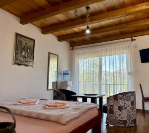 a bedroom with a bed and a table and a window at S&M Apartments in Rijeka Crnojevića