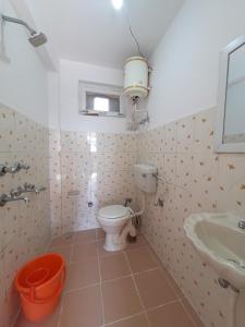 a bathroom with a toilet and a sink at Be Happy HomeStay in McLeod Ganj