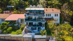 a large white house with a sign on it at Nakas Suites in Fethiye