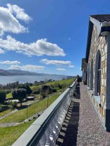 a building with a view of a body of water at Beautiful House on Wild Atlantic Way - 6 bedrooms in Kenmare
