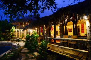 a house with a wooden deck in front of it at night at Duân Thảo homestay in Hòa Bình