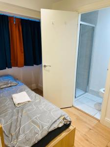 a bedroom with a bed and a bathroom with a shower at Tiny but private & best Location in London