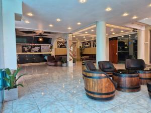 a lobby with leather chairs and tables and a lobby at Mountview Tourist Residence in Quatre Bornes