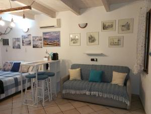 a room with a bed and a table and a couch at Il Posto Nascosto in Porto Torres
