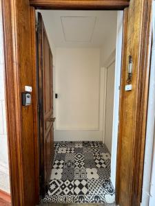 eine offene Tür mit einem schwarz-weißen Fliesenboden in der Unterkunft Studio hypercentre Tassin La Demi Lune in Tassin-la-Demi-Lune