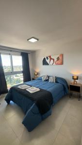 a bedroom with a large blue bed in a room at Guesthouse Luxury in Cordoba