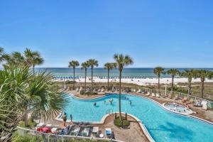 an overhead view of a swimming pool with the beach at Grand Panama 1-303 in Panama City Beach