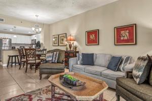 a living room with a couch and a table at Grand Panama 1-303 in Panama City Beach