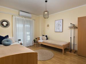 a living room with two beds and a window at Marisan Seaview Apartment in Funtana