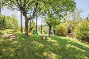 un parc avec un banc et une aire de jeux dans l'établissement Ferienwohnung für 4 Personen ca 65 qm in Radicondoli, Toskana Provinz Siena, à Radicondoli