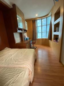 a bedroom with a bed and a desk and window at Parkview KLCC ITSKAYA 11 in Kuala Lumpur