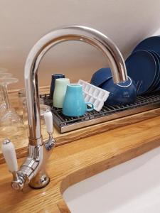 a kitchen counter with a sink and a sink at Langford Executive Apartments in Bristol