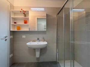 a bathroom with a sink and a glass shower at Sacro Cuore Relais in Negrar