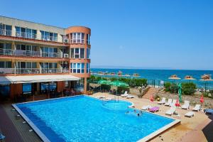 a hotel with a large swimming pool next to the ocean at Complex Relax Pomorie All Inclusive in Pomorie