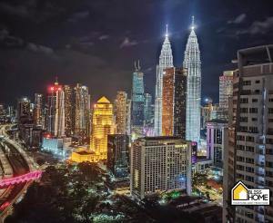 a city skyline at night with many tall buildings at 188 Suites KLCC By Bliss Home At City Centre in Kuala Lumpur