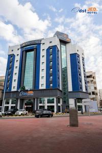 a blue and white building with a car in front of it at Odst Jeddah in Jeddah