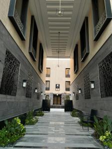 an empty hallway of a building with chairs and plants at شقة فندقية الماجدية مدخل خاص in Riyadh