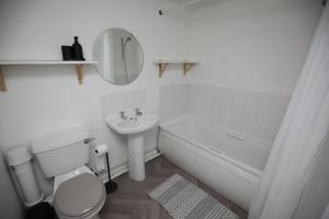 a white bathroom with a toilet and a sink at Luxury 1 Bed - Duplex Apartments in Leicester