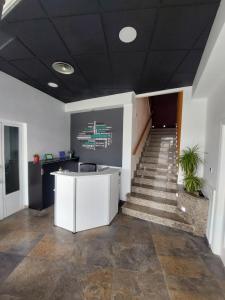 an office with a staircase with a desk and a stair case at Hotel Cervantes in Mahora