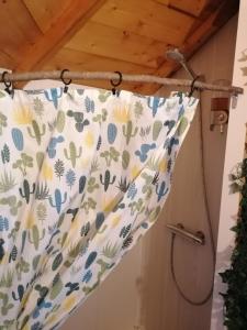 a shower curtain hanging from a wooden ceiling at SHERWOOD TREE in Étretat