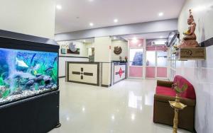 a living room with a fish tank in the middle at Hotel Suraj Inn in Surat