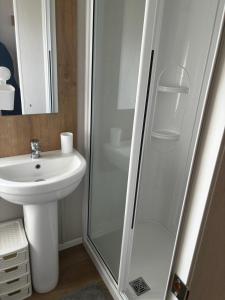 a bathroom with a shower and a sink at Ataraxia - Ocean Edge Resort - 8 Berth Accommodation in Heysham