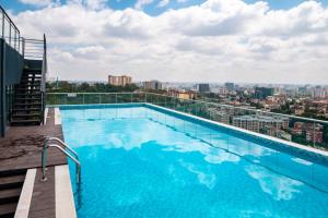 a swimming pool on the roof of a building at Paul Apartments in Nairobi